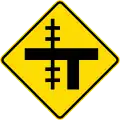 (W15-2.1/PW-13.3) Railway level crossing on uncontrolled T-junction to left