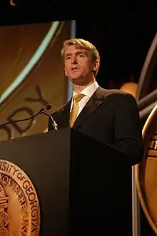 Nic Robertson standing at a lectern