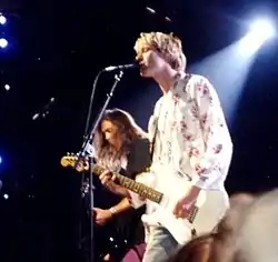 Nirvana performing live at the 1992 MTV Video Music Awards. Kurt Cobain is in the foreground and Krist Novoselic is in the background