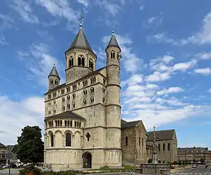 Sainte-Gertrude, Nivelles, Belgium, a sturdy church screened behind a large westwerk.