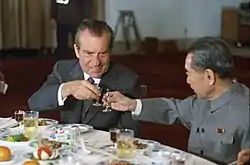 President Nixon and Chinese Premier Zhou Enlai toast one another during the former's visit to the People's Republic of China.  The two are credited with forging a new axis in the Cold War out of mutual hostility to the Soviet Union.