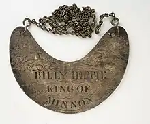 Brass crescent shaped plate inscribed  Billy Hippie King of Minnon