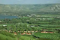 Kvutzat Kinneret (foreground) from west, overlooking the Sea of Galilee and the Jordan Valley and opposite the Golan Heights (background)