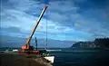 Crane on Kingston Pier unloading cargo from a lighter