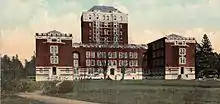 A U-shaped building with a nine-floor tower