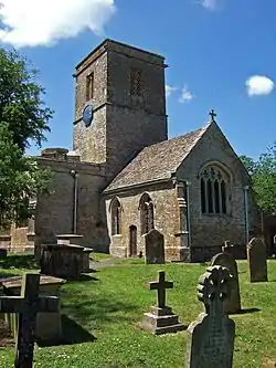 Stone building with square tower.