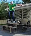 A skateboarder making use of street furniture.