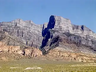 Grey carbonate rocks, pink monzonite, white marl