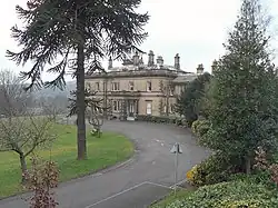 small two-storey building in a parkland setting