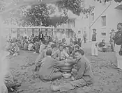 Prison inmates on Oahu eating poi circa 1890