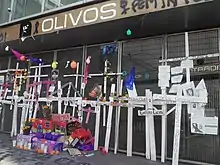 Twenty-six crosses with the names of the deceased are on the protective fence of Olivos station.