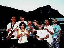 Oingo Boingo circa 1990. From left to right: Sam "Sluggo" Phipps, Steve Bartek, John Avila, Johnny "Vatos", Danny Elfman, Dale Turner, Carl Graves, Leon Schneiderman