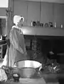 Food preparation demonstration in an early 19th-century kitchen