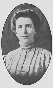 A white woman in an oval frame, wearing a dress with a pleated yoke and high collar