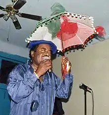 Oliver Morgan on stage with his trademark second-line umbrella, 1997