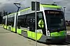 A green and gray tram