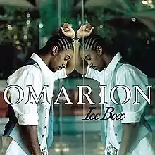 An image of a black man in a white dress shirt and grey vest putting his arm on a mirror wall. The artist's name and song title are superimposed above the image.