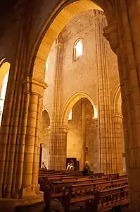 Very few and narrow openings giving it a grim environment, typical of Romanesque style