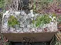 A highly ornate planter or trough near the walled garden