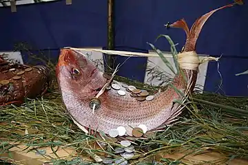 Red seabream as an auspicious object, with straw bindings and coins at Osaka Tenmangū shrine