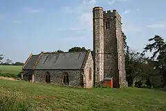 Stone building with square tower.