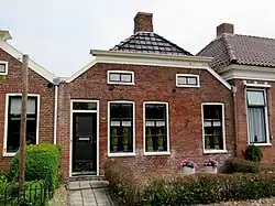 Three houses made of red bricks