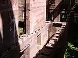 View of a ruined building with trees growing through and floors missing.