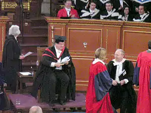 Scarlet academic gowns are worn by new Doctors of Philosophy at a degree ceremony at Oxford University.