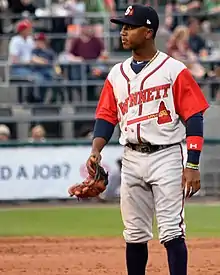 A baseball player in a gray uniform