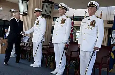 Navy officers in full dress white uniform  at the PACOM change-of-command ceremony, Camp Smith, Hawaii, Oct. 19, 2009.