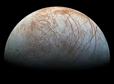 Image 17Europa (moon)Photo credit: NASA/JPLRealistic-color mosaic of images of Jupiter's moon Europa taken by NASA's Jupiter orbiter Galileo in 1995 and 1998. This view of the moon's anti-Jovian hemisphere shows numerous lineae, linear features created via a tectonic process in which crustal plates of water ice floating on a subsurface ocean (kept warm by tidal flexing) shift in relative position. Reddish regions are areas where the ice has a higher mineral content. The north polar region is at right. (Geologic features are annotated in Commons.)More selected pictures