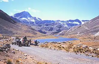 Cavers at Pumaqucha offloading equipment for Sima Pumaqucha. The southern slopes of Uchku are on the left.