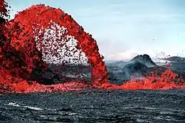 Geology: parabola-shaped lava flow illustrates Galileo's law of falling bodies, as well as blackbody radiation. The temperature can be discerned from the color of the blackbody.