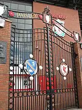 A set of gates with the inscription "Paisley Gateway" at the top. In the middle of the sets of gates are two emblems