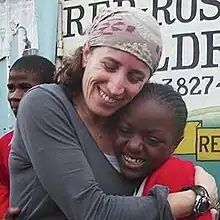 Pam Allyn and a LitWorld student hug each other in Kisumu, Kenya in 2011.