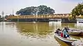 Fishermen unloading supplies from their boat in the river.