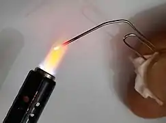 Paper clip turned red as a result of the flam