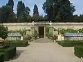 The entrance to the grotto, against the back wall of the garden.