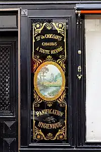 Neoclassical medallion on the facade of Le Moulin de la Vierge (Rue Saint-Dominique no. 64), Paris, by Benits et Fils, c.1900