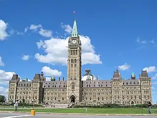 Centre Block of the Parliament of Canada buildings, with the Peace Tower and Canadian flag flying