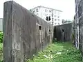 The rear-area of the pillbox, with square holes placed in the defensive-wall provided to allow troops to fire on approaching enemy soldiers getting too close to entering the structure.