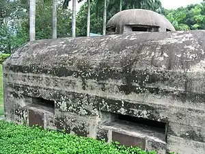 Two gun embrasures shown together with the rounded observation cupola on the roof of the pillbox.