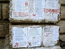 Detail of modern pasquinades glued to the base of Pasquino