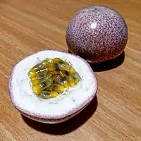 A ripe passionfruit, cut in half to show the insides