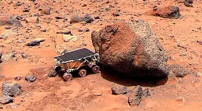 Sojourner performs spectrometer measurements on the "Yogi" rock.