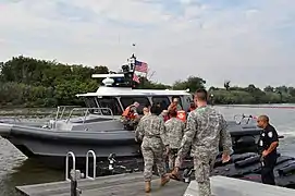 Members of the New York Army National Guard join members of the New York State Naval Militia, the Port Authority Police Department and the Coast Guard Reserve.