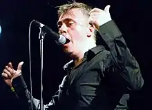 Paul McLoone performing on stage with The Undertones in Holmfirth, England, United Kingdom on Saturday 14 July 2012