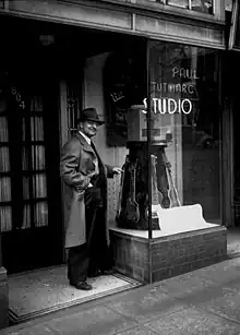 Paul Tutmarc outside his Seattle music studio