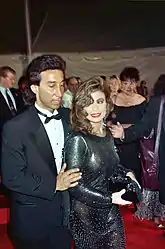 Image 27Actress Paula Abdul wearing semi-transparent black dress, curled hair and smoky eye makeup, 1990. (from 1990s in fashion)