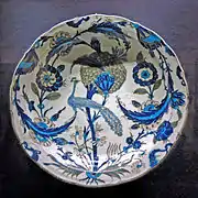 Dish covered with rosettes, saz leaves and a peacock, c. 1540–1555